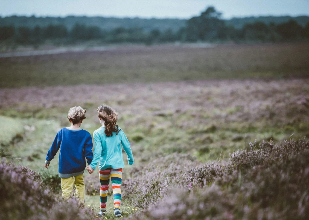 boy and girl walking in field